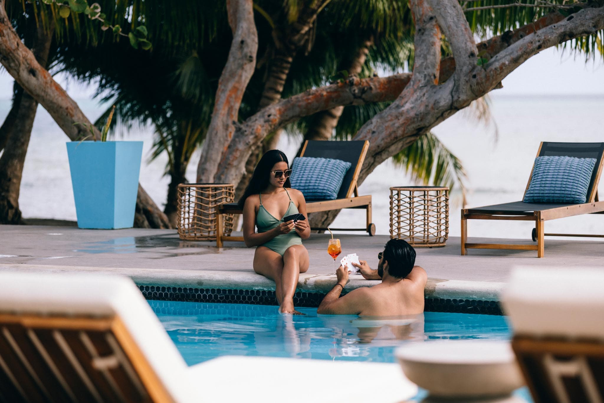 A man and a woman relaxing in the pool at Blue Reef Beach in Placencia A man and a woman relaxing in the pool at Blue Reef Beach in Placencia